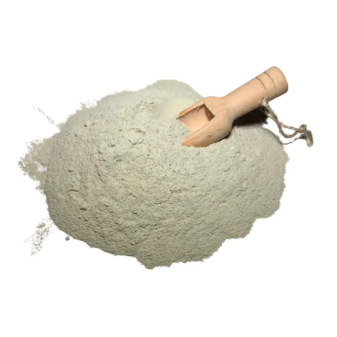 Natural green clay powder with a wooden scoop, ideal for detoxifying facial masks and deep cleansing.