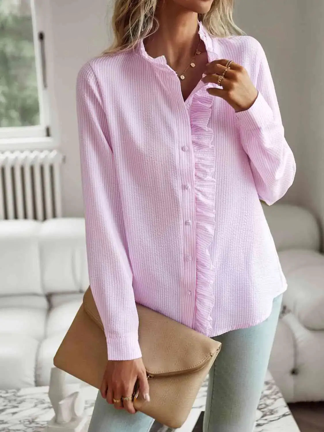 Model wearing a light pink Nat Ruffle Trim Long Sleeve Shirt, showcasing ruffle detail and stylish casual look.